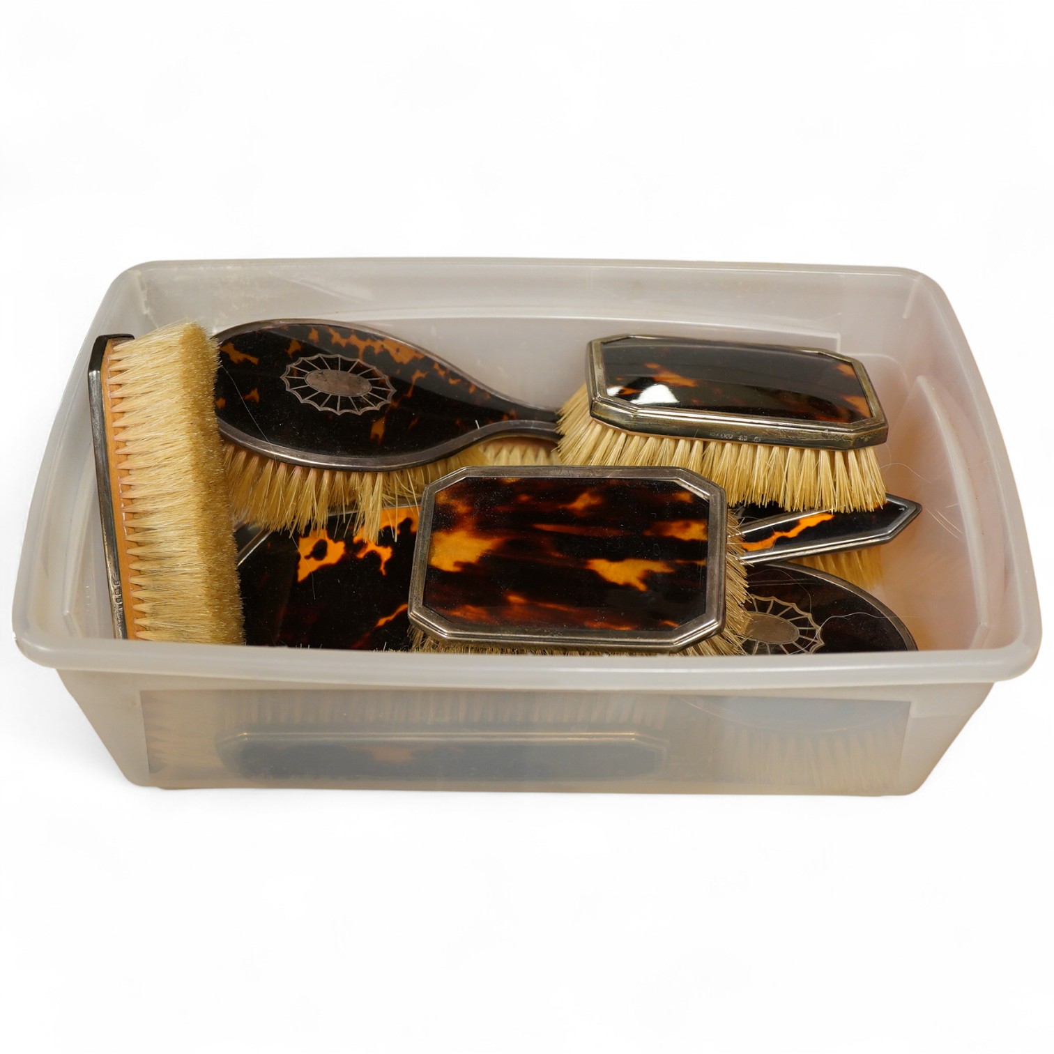 Two George V silver mounted tortoiseshell five piece dressing table sets, first Birmingham, 1925, Levi & Salaman, inlaid with fan paterae second in Art Deco style London, 1931, Collett & Anderson, (10)